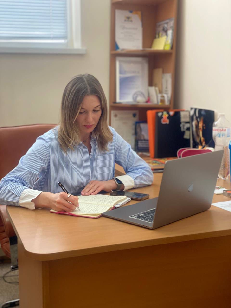 людина сидить за ноутбуком